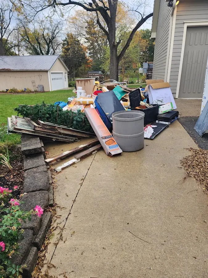 Dumpster being loaded with debris for Commercial Dumpster Rental in Kings Park